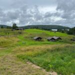Traditional wooden cottage in Mebalovo village along Klyazma River with birch forest and tranquil rural Russian scenery