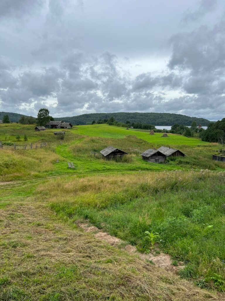 Traditional wooden cottage in Mebalovo village along Klyazma River with birch forest and tranquil rural Russian scenery